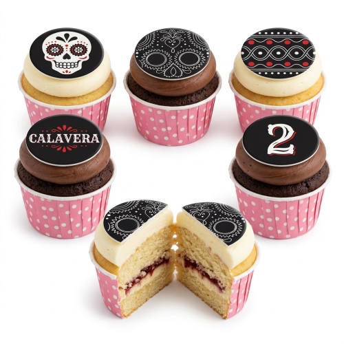 Assortment of Sugar Skull and Calavera themed cupcakes with black, white, and red designs, including a custom age topper.