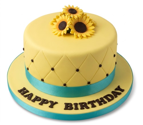 Round yellow sunflower birthday cake with quilted pattern, brown dots, teal ribbon, and "Happy Birthday" message.