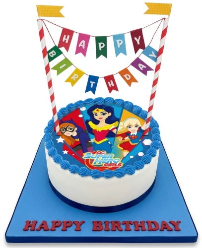Round white cake with DC Super Hero Girls edible image, blue frosting, and "Happy Birthday" banner.