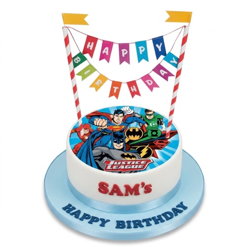 Round white cake with Justice League superhero edible topper and 'Happy Birthday' banner.