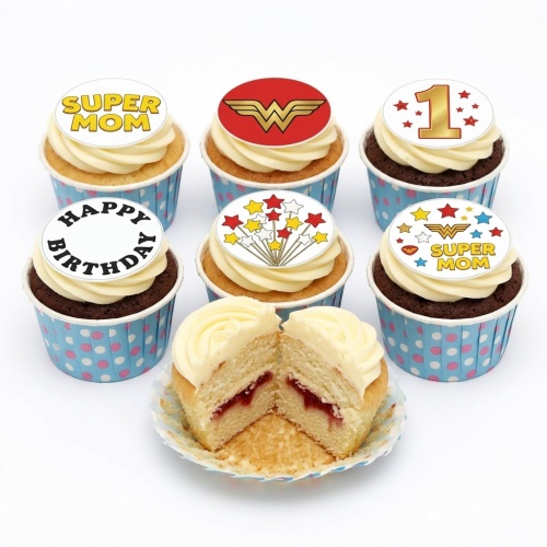 A set of Super Mom Wonder Woman themed cupcakes with white frosting and various edible toppers, including a Wonder Woman logo, 'SUPER MOM' text, 'HAPPY BIRTHDAY' text, a gold number 1, and stars, with one cupcake cut open to show a jam filling.
