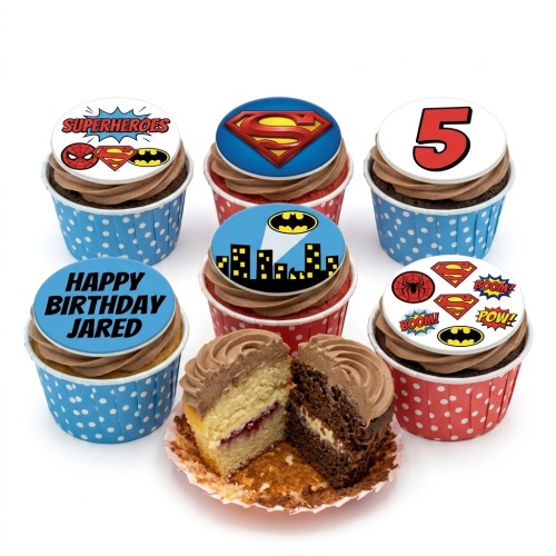Superhero themed cupcakes with Batman, Superman, and Spiderman logos, comic book designs, and custom age topper.
