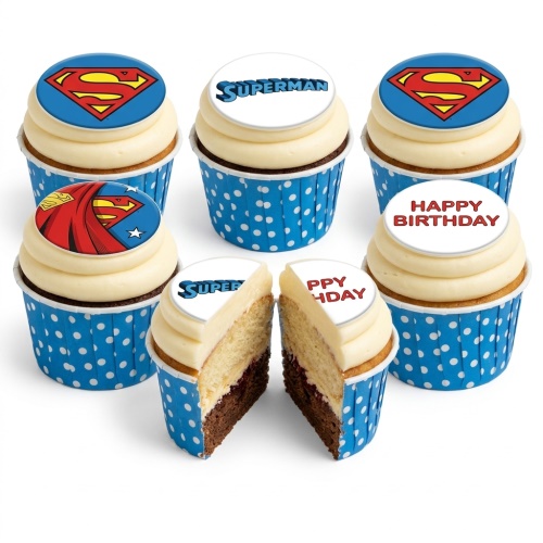 Set of six Superman themed cupcakes with blue polka dot cases and cream frosting, featuring Superman logo and text toppers.