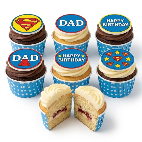Set of Superman themed birthday cupcakes with 'DAD' and 'Happy Birthday' toppers in blue polka dot cases.