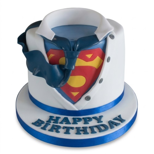 Superman themed birthday cake with a white shirt, blue tie, and red and yellow logo, with 'Happy Birthday' message.