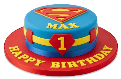 Round blue and red Superman themed birthday cake with yellow 'S' shield, custom age '1' and name 'MAX'.