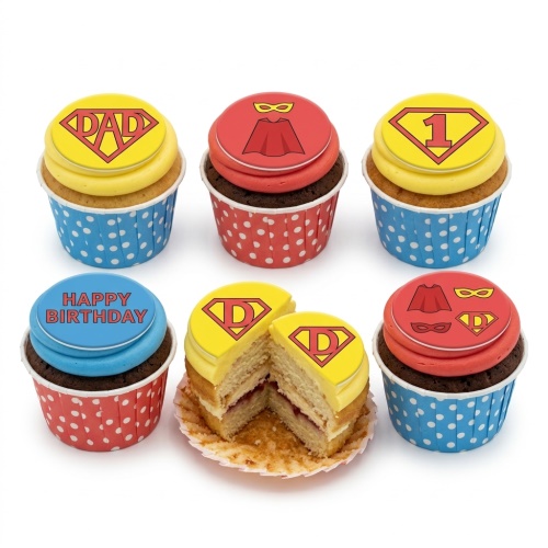 Superhero themed cupcakes with shield logo, cape, and masks, featuring custom age and message toppers.