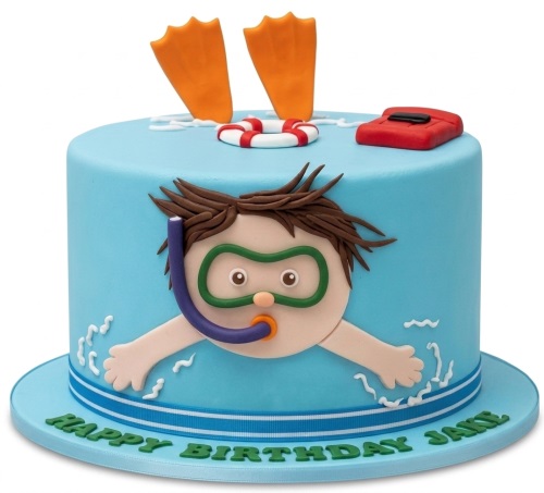 Round blue cake with a snorkelling boy, orange flippers, a lifebuoy, and a red float.