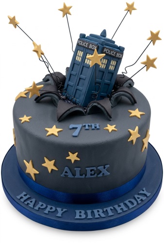 Round blue-grey Doctor Who TARDIS birthday cake with gold stars, custom age, and name.
