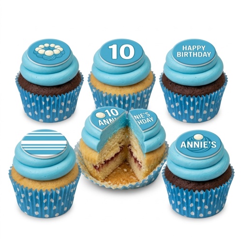 Six blue cupcakes with custom age, name, and happy birthday toppers, some with polka dot wrappers.