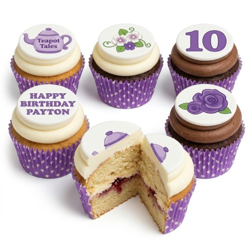 A selection of cupcakes in purple polka dot cases, topped with white frosting and edible discs featuring purple flowers, a teapot, and the number 10.