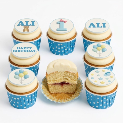 1st birthday cupcakes for boys with blue polka dots, teddy bear, balloons, and baby shoe toppers.