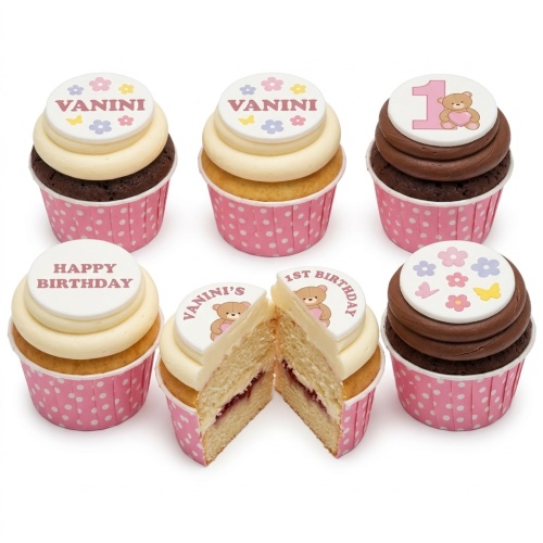 Set of six cupcakes with pink polka dot wrappers, featuring teddy bear and floral toppers, some with '1st Birthday' and 'Happy Birthday' messages.
