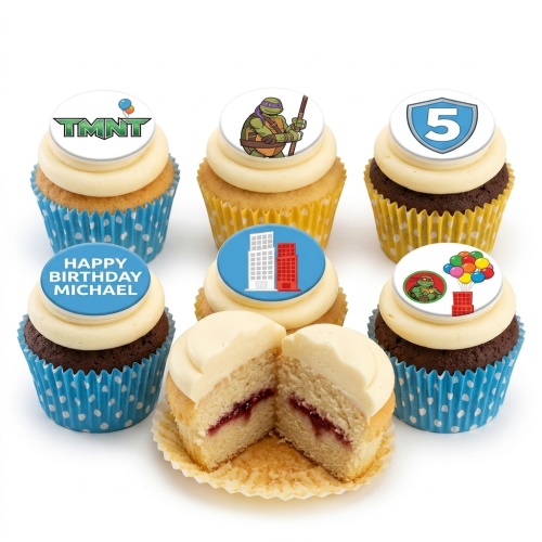 Set of Teenage Mutant Ninja Turtles themed cupcakes with various toppers including TMNT logo, turtle character, city buildings, and balloons.