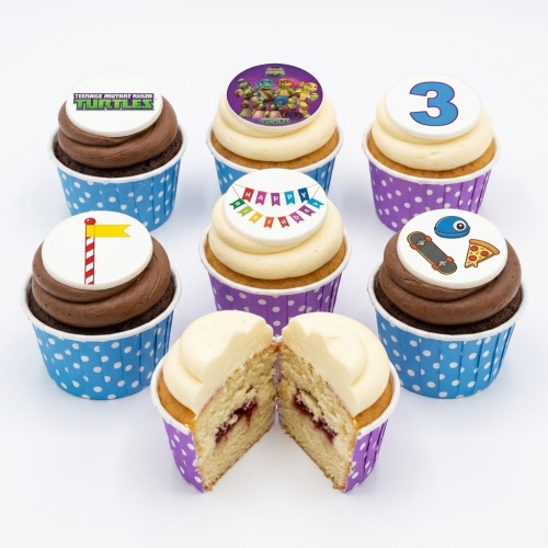 Teenage Mutant Ninja Turtles themed birthday cupcakes with chocolate and vanilla frosting, custom age topper, and "Happy Birthday" banner.