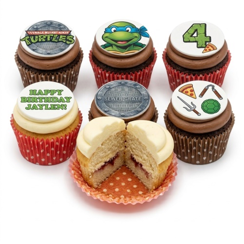 Set of Teenage Mutant Ninja Turtles themed cupcakes with character, logo, sewer grate, pizza, and ninja weapon toppers, with one cupcake cut open.