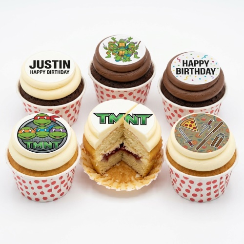 Teenage Mutant Ninja Turtles cupcakes with character toppers, TMNT logo, pizza, and ninja weapons.