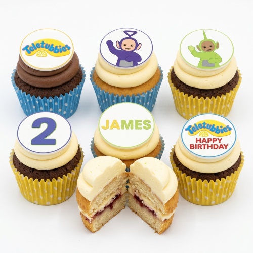 A selection of Teletubbies themed cupcakes with logo, character, custom age '2', and name 'James' toppers.