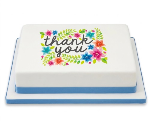 White square cake with a blue ribbon and an edible print of "thank you" surrounded by colourful watercolour flowers.