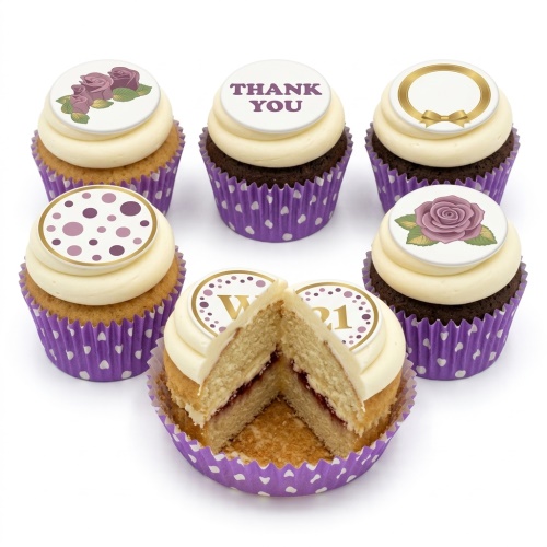 Elegant cupcakes with white frosting, purple wrappers, floral rose toppers, polka dots, and custom age initial.