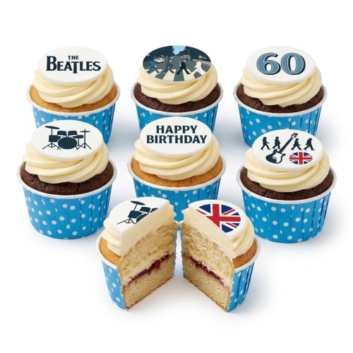The Beatles themed cupcakes with white frosting, blue polka dot cases, and edible toppers including the band logo, Abbey Road, drum kit, guitar, Union Jack, and a custom age topper.