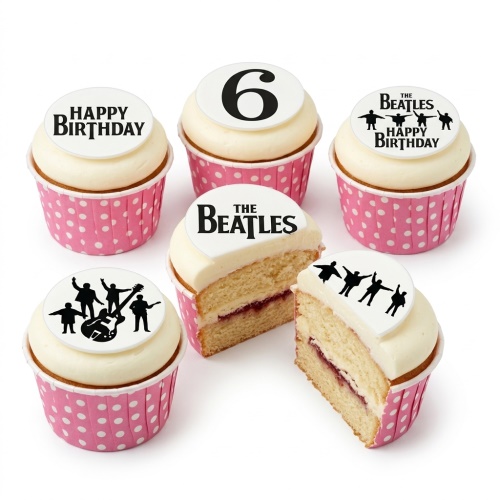 White cupcakes with Beatles logo, band silhouettes, Happy Birthday and number 6 toppers in pink polka dot wrappers.