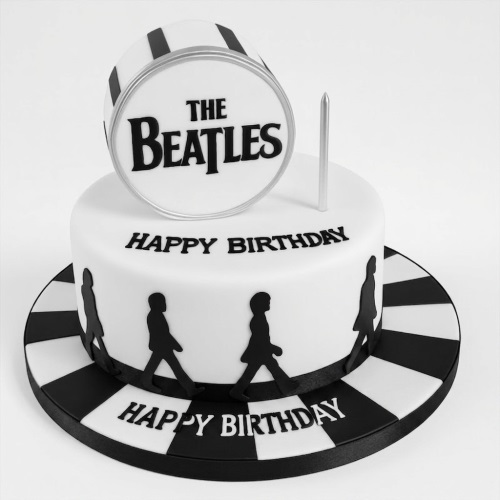 White and black two-tier Beatles Abbey Road themed birthday cake with drum logo and band silhouettes.