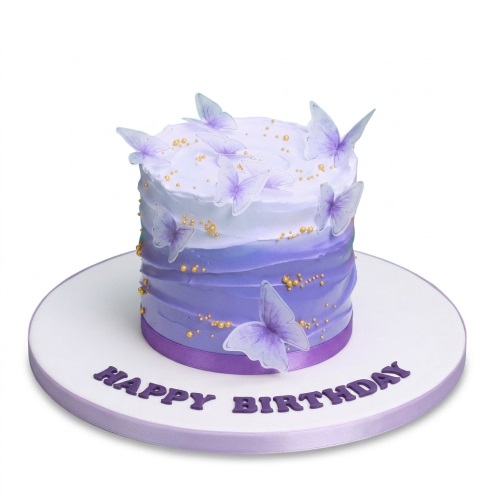Round purple ombre birthday cake with edible butterflies and gold sprinkles.