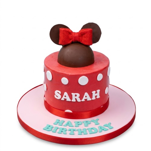 Round red cake with white polka dots, Minnie Mouse ears, red bow, and 'Happy Birthday' message.