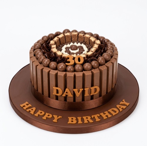 Round chocolate birthday cake with KitKat bars, Maltesers, and a custom age topper.