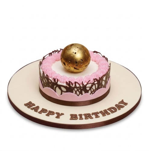 Round birthday cake with a gold sphere, pink piping, and chocolate lattice.