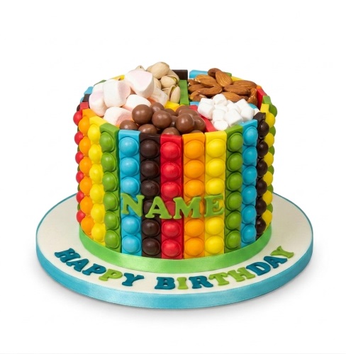 Round rainbow Pop It themed birthday cake with marshmallows, chocolate balls, pistachios, and almonds on top.