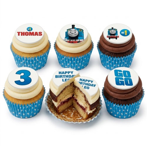 Thomas The Tank Engine themed cupcakes with vanilla and chocolate frosting, blue polka dot wrappers, and custom age/name toppers.
