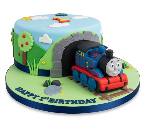 Thomas The Tank Engine themed 1st birthday cake with a train, tunnel, and green landscape.