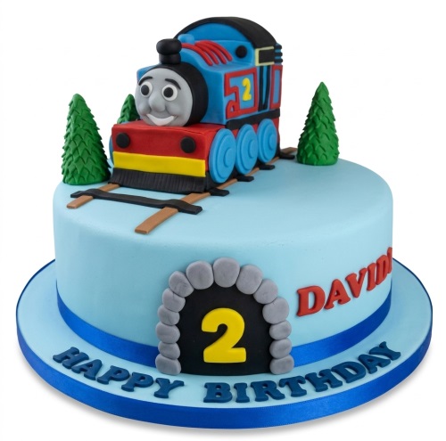 Light blue round birthday cake with a 3D Thomas the Tank Engine topper, green trees, and a custom age tunnel.