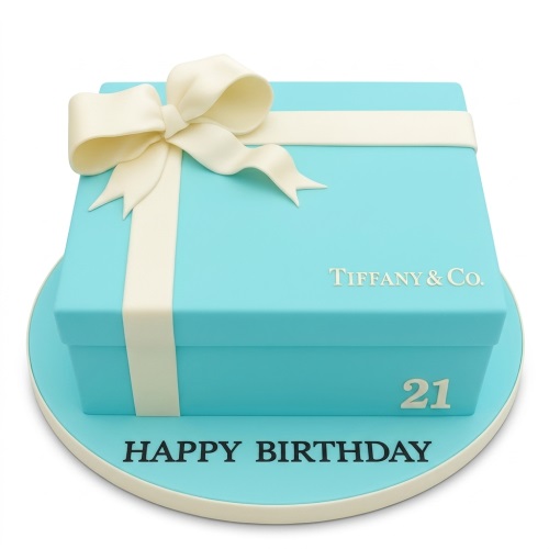 Tiffany style gift box birthday cake with a white ribbon and bow, on a blue cake board with 'Happy Birthday' written.