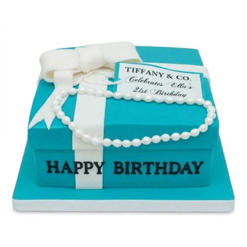 Teal gift box birthday cake with white ribbon, bow, and pearl necklace, with 'Happy Birthday' text.