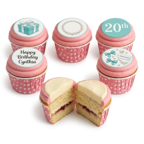 Elegant pink cupcakes with teal gift box, pearl necklace, bows, and custom age topper.