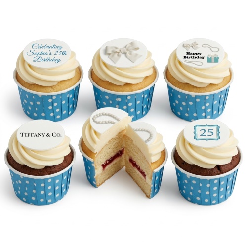 Elegant birthday cupcakes for her with white bows, pearls, and custom age toppers in blue and white polka dot wrappers.