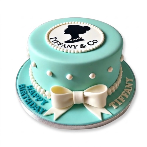 Round Tiffany blue birthday cake with a white bow and "Tiffany & Co" silhouette on top.