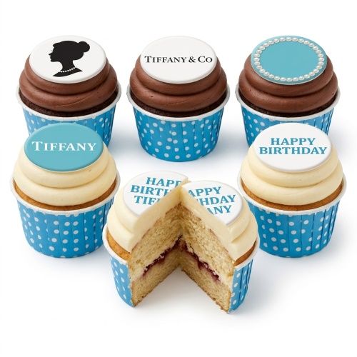 Set of Tiffany inspired cupcakes with blue and white toppers, chocolate and vanilla frosting, and polka dot cases.