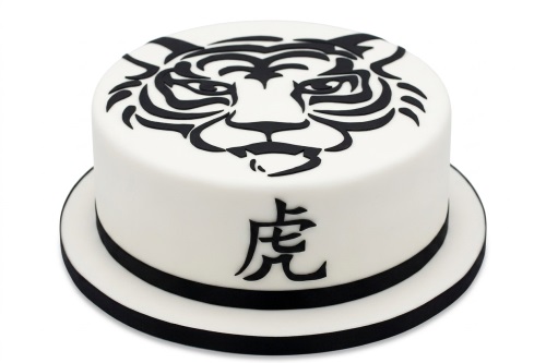Round white fondant cake with a black stylised tiger face design on top and a black Chinese tiger character on the side.