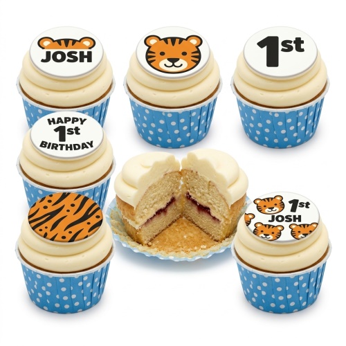 Set of tiger theme birthday cupcakes with tiger face, stripe, custom name, and custom age toppers in blue polka dot wrappers.
