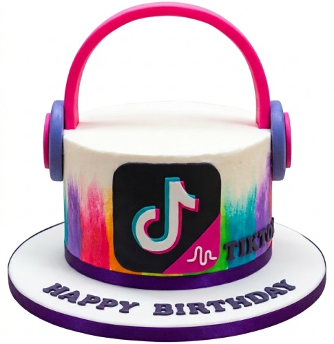 Round white TikTok theme birthday cake with colourful sides, black logo, and pink headphones.
