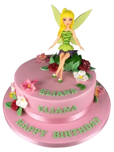 Two-tier pink fondant cake with a fairy figurine, red, white, and pink sugar flowers, and green leaves.