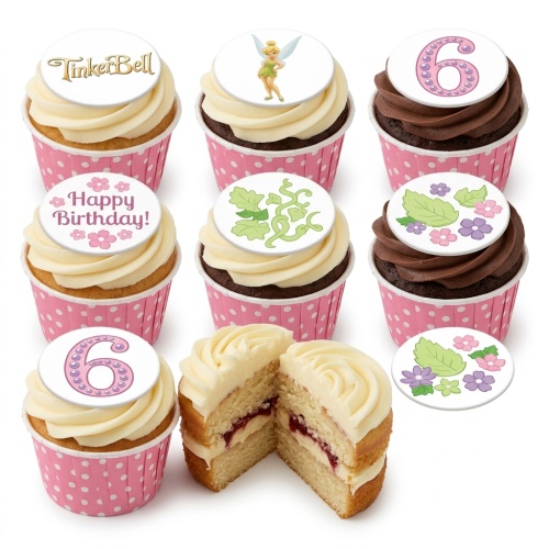 A selection of TinkerBell themed birthday cupcakes with white and chocolate frosting, pink polka dot wrappers, and various edible toppers including TinkerBell, 'Happy Birthday!', a number 6, and floral designs.