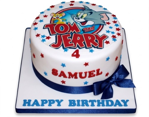 Round white Tom and Jerry birthday cake with red and blue stars, blue ribbon, and custom age.