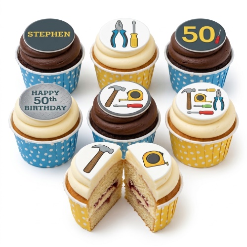 Assortment of tools theme birthday cupcakes with edible toppers of hammers, screwdrivers, pliers, and tape measures, in blue and yellow polka dot cases.