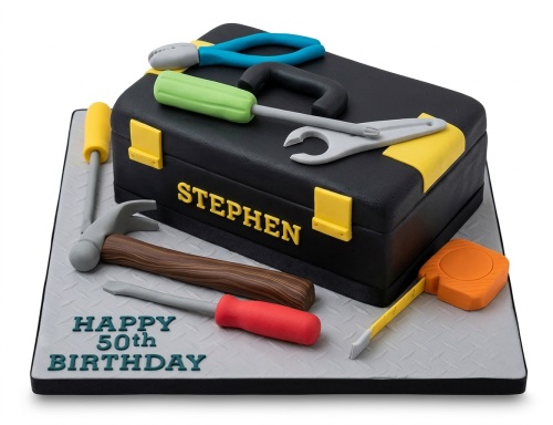 Black toolbox cake with edible sugarpaste tools like hammer, screwdrivers, and tape measure, for a personalised birthday.