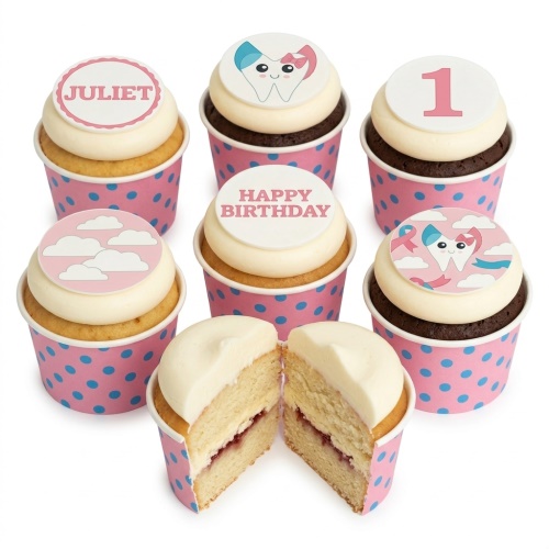 Cupcakes with white frosting, pink polka dot cases, and edible toppers with a cartoon tooth, clouds, and custom age.
